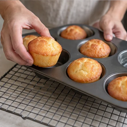 Step 6: Leave in the tin for 5 minutes, then gently loosen and transfer to a rack. Let cool enough to handle before eating. Serve 2 cakes per person; they are best warm, with crisp edges and a chewy center.